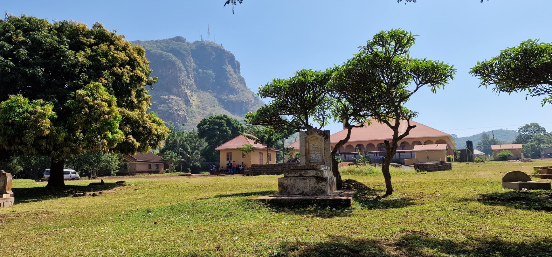 Wide view of the Tororo burial ground with buildings and Tororo Rock