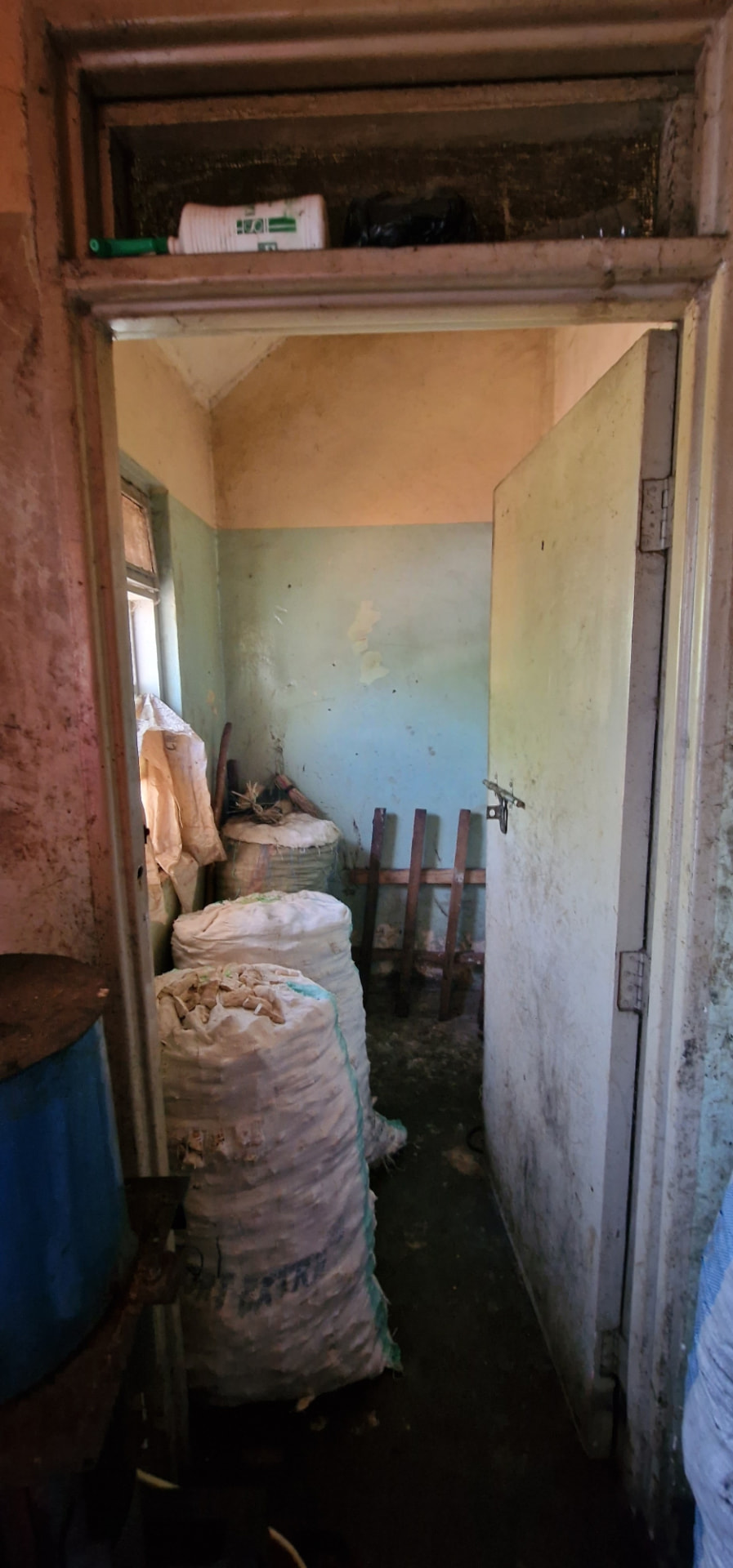 Doorway into a store room stacked with sacks